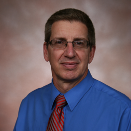 A man in a blue shirt and a tie