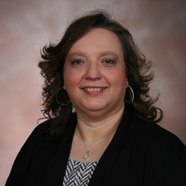 A woman is smiling at the camera